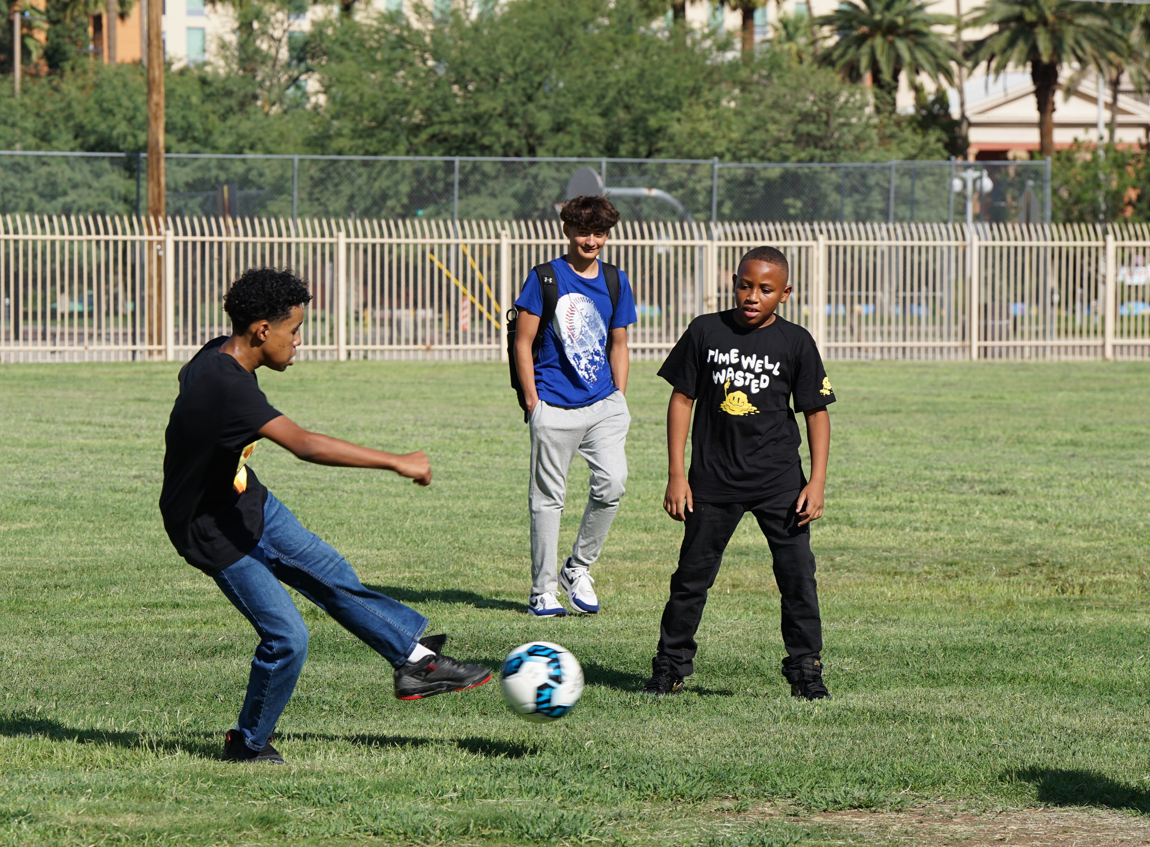 Middle school boys play soccer on the field