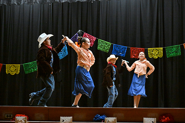 Elementary students perform a dance